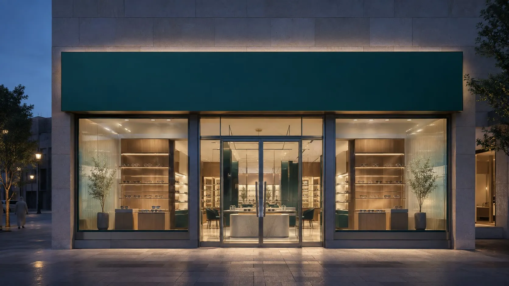 Exterior signage: the lockup illuminated on the shopfront fascia at dusk